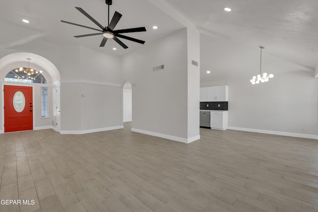 4321 Loma Casitas Rd, El Paso, TX 79934 - unfurnished living room featuring a chandelier, high vaulted ceiling, arched walkways, a ceiling fan, and light wood-type flooring