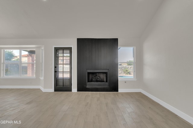 4321 Loma Casitas Rd, El Paso, TX 79934 - unfurnished living room with wood finished floors, a fireplace, and vaulted ceiling