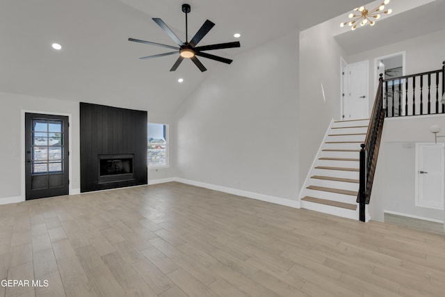 4321 Loma Casitas Rd, El Paso, TX 79934 - unfurnished living room with stairs, a chandelier, light wood-style floors, recessed lighting, and high vaulted ceiling