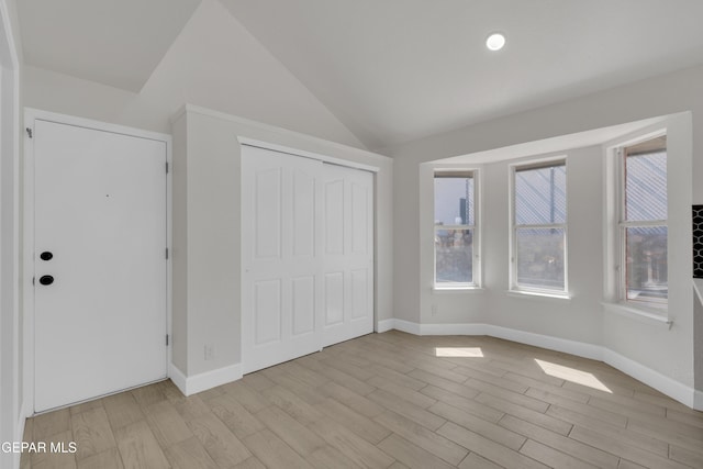 4321 Loma Casitas Rd, El Paso, TX 79934 - unfurnished bedroom with lofted ceiling, light wood-style flooring, and a closet