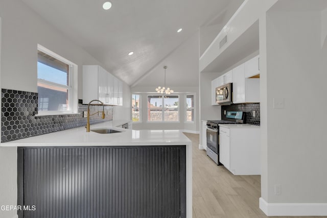 4321 Loma Casitas Rd, El Paso, TX 79934 - kitchen featuring stainless steel appliances, white cabinetry, recessed lighting, plenty of natural light, and decorative backsplash