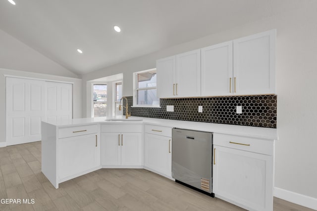 4321 Loma Casitas Rd, El Paso, TX 79934 - kitchen with dishwasher, backsplash, white cabinets, vaulted ceiling, and light countertops