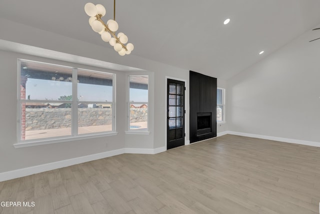 4321 Loma Casitas Rd, El Paso, TX 79934 - unfurnished living room with lofted ceiling, light wood finished floors, a fireplace, recessed lighting, and a chandelier