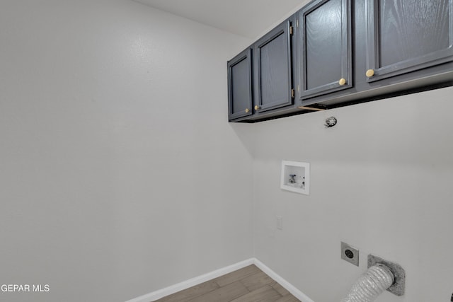 4321 Loma Casitas Rd, El Paso, TX 79934 - laundry area featuring electric dryer hookup, cabinet space, hookup for a washing machine, and light wood-style flooring