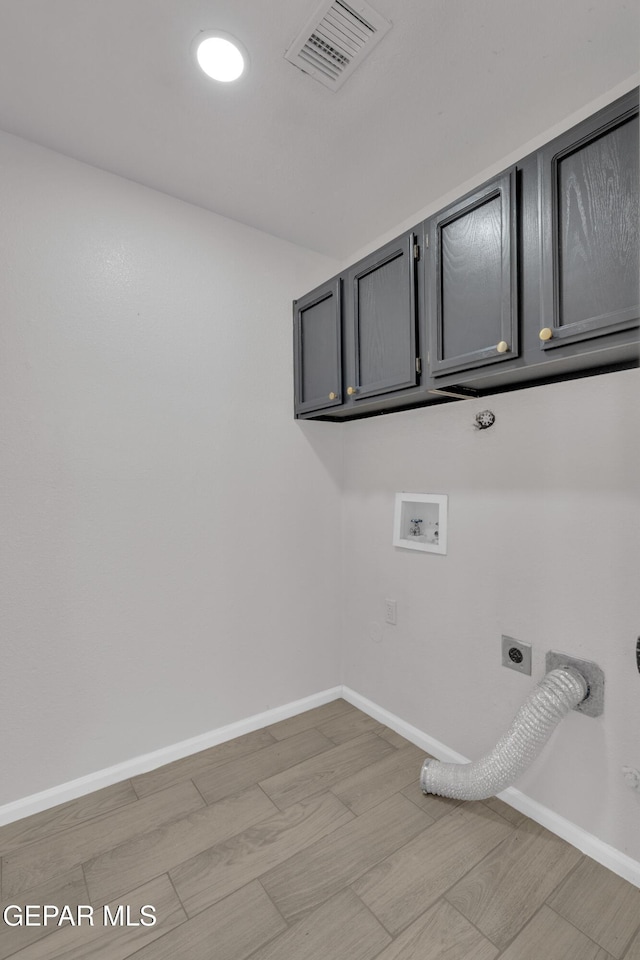 4321 Loma Casitas Rd, El Paso, TX 79934 - washroom featuring cabinet space, hookup for an electric dryer, hookup for a washing machine, hookup for a gas dryer, and light wood-style floors