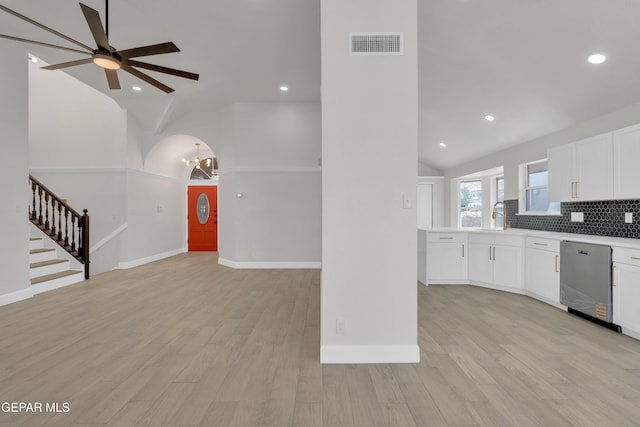 4321 Loma Casitas Rd, El Paso, TX 79934 - kitchen with stainless steel dishwasher, lofted ceiling, white cabinets, tasteful backsplash, and a ceiling fan