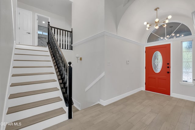 4321 Loma Casitas Rd, El Paso, TX 79934 - entryway featuring a chandelier, light wood-type flooring, lofted ceiling, and stairs