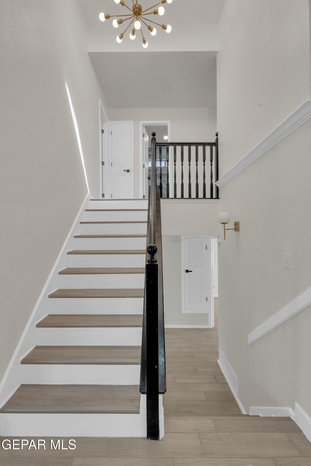 4321 Loma Casitas Rd, El Paso, TX 79934 - staircase with a chandelier and wood finished floors