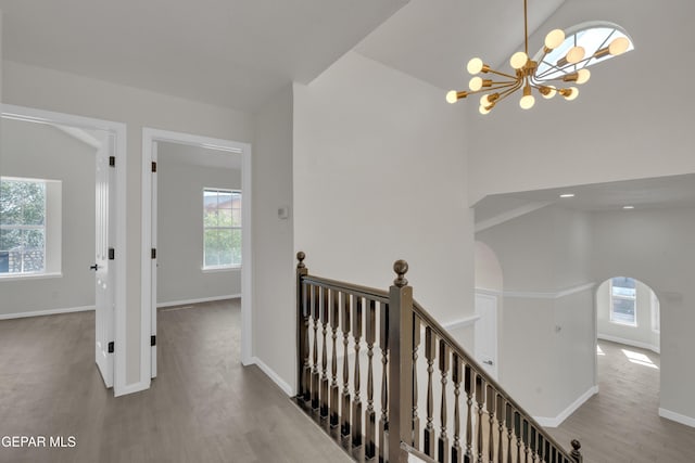 4321 Loma Casitas Rd, El Paso, TX 79934 - hall featuring wood finished floors, a chandelier, plenty of natural light, arched walkways, and a towering ceiling