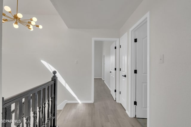 4321 Loma Casitas Rd, El Paso, TX 79934 - corridor with a chandelier, wood finished floors, and an upstairs landing