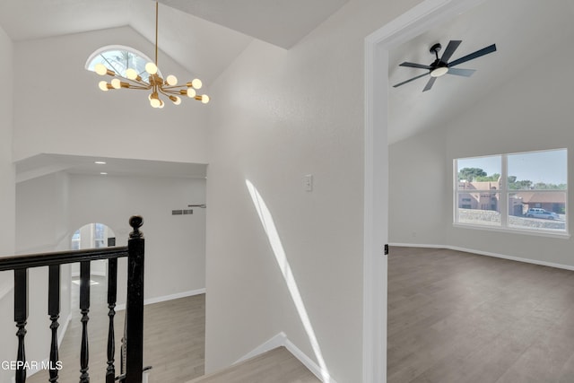 4321 Loma Casitas Rd, El Paso, TX 79934 - stairs featuring a chandelier, healthy amount of natural light, wood finished floors, and high vaulted ceiling