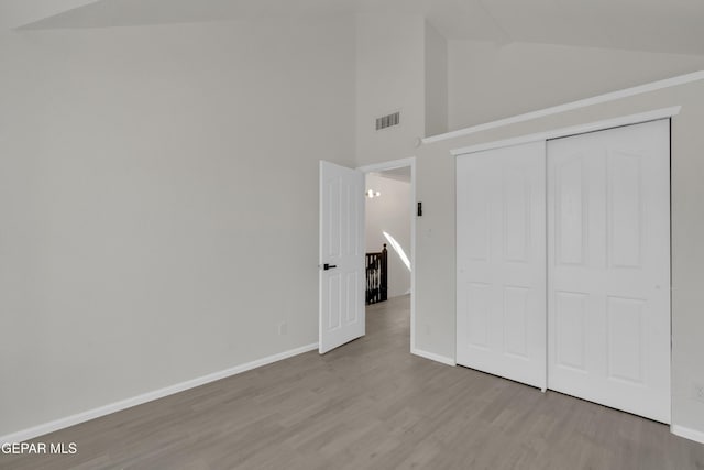 4321 Loma Casitas Rd, El Paso, TX 79934 - unfurnished bedroom with wood finished floors, a closet, and high vaulted ceiling
