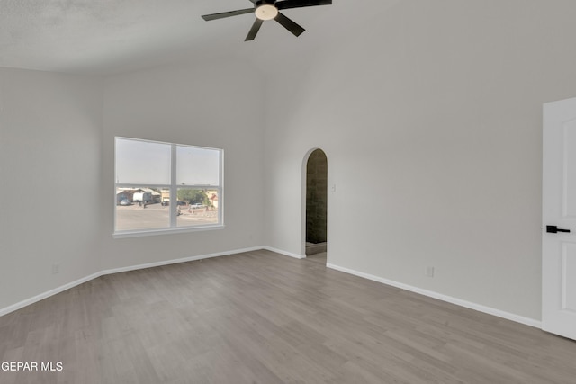 4321 Loma Casitas Rd, El Paso, TX 79934 - unfurnished room featuring arched walkways, ceiling fan, high vaulted ceiling, and wood finished floors
