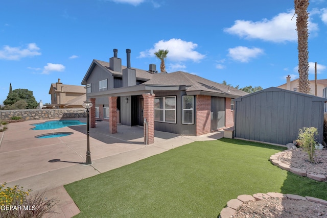 4321 Loma Casitas Rd, El Paso, TX 79934 - rear view of property featuring brick siding, a patio, a storage unit, and a shingled roof