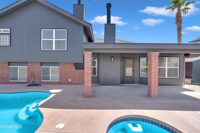 4321 Loma Casitas Rd, El Paso, TX 79934 - back of house with a chimney, a patio, an outdoor pool, and brick siding