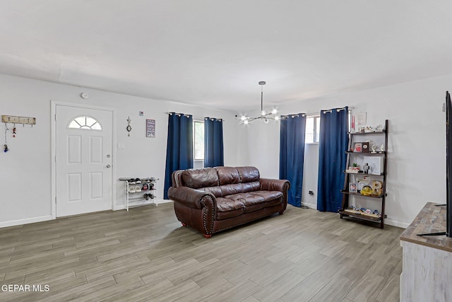 9128 Diana Dr, El Paso, TX 79924 - living room with a chandelier, light wood-style flooring, and plenty of natural light