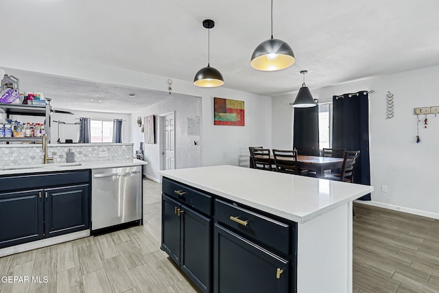 9128 Diana Dr, El Paso, TX 79924 - kitchen featuring dishwasher, light countertops, decorative backsplash, pendant lighting, and light wood-type flooring