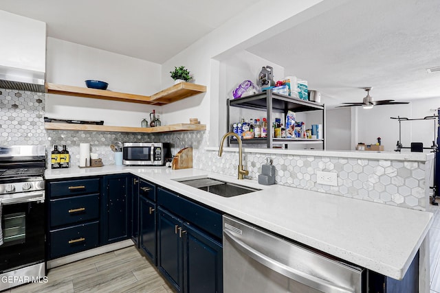 9128 Diana Dr, El Paso, TX 79924 - kitchen featuring appliances with stainless steel finishes, open shelves, blue cabinets, light countertops, and decorative backsplash