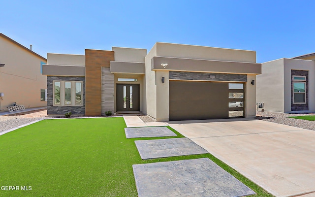 13816 Summer Camp Ct, El Paso, TX 79928 - contemporary house with a garage, concrete driveway, french doors, a putting area, and stucco siding