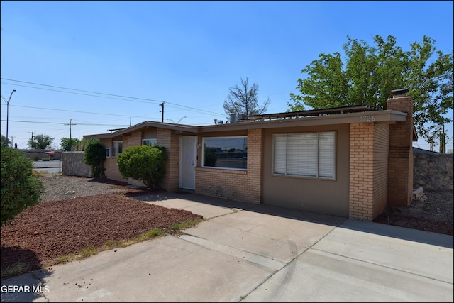 5726 Dearborne Dr, El Paso, TX 79924 - ranch-style home featuring brick siding, a chimney, and a patio