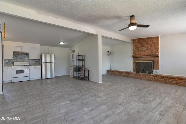 5726 Dearborne Dr, El Paso, TX 79924 - unfurnished living room featuring a ceiling fan, a fireplace, and a textured ceiling