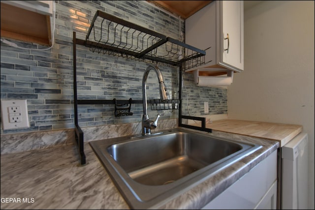 5726 Dearborne Dr, El Paso, TX 79924 - kitchen with decorative backsplash and white cabinetry