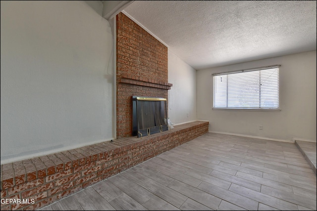 5726 Dearborne Dr, El Paso, TX 79924 - unfurnished living room with a fireplace, a textured ceiling, and wood finished floors