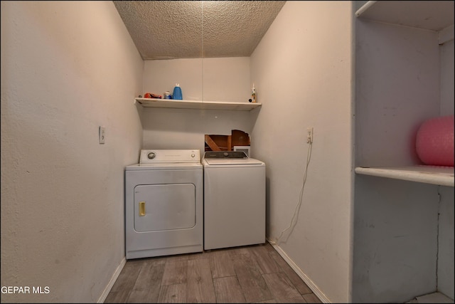 5726 Dearborne Dr, El Paso, TX 79924 - laundry room featuring washer and dryer, wood finished floors, and a textured ceiling