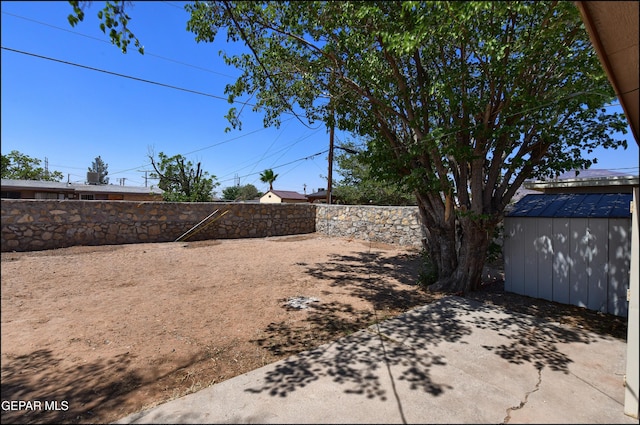 5726 Dearborne Dr, El Paso, TX 79924 - fenced backyard featuring a patio area and a storage unit