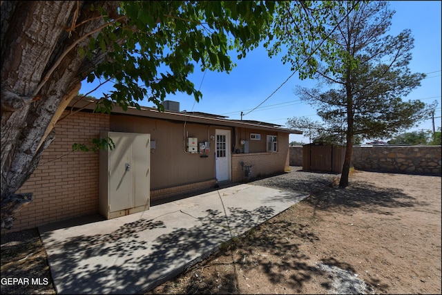 5726 Dearborne Dr, El Paso, TX 79924 - back of house with brick siding, a shed, and a patio