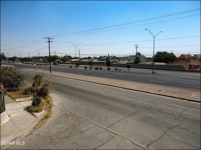 5726 Dearborne Dr, El Paso, TX 79924 - view of asphalt road with street lighting, sidewalks, and curbs