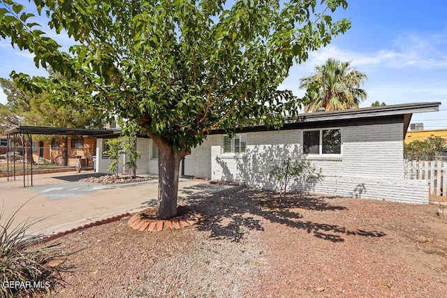 8142 Cook Dr, El Paso, TX 79907 - view of front of property with brick siding, a carport, driveway, and a patio