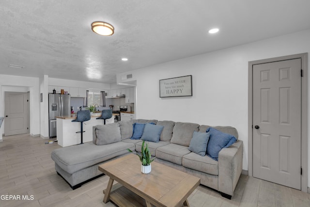 8142 Cook Dr, El Paso, TX 79907 - living room with light wood-type flooring and recessed lighting