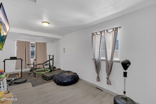 8142 Cook Dr, El Paso, TX 79907 - workout area featuring light wood-type flooring and baseboards