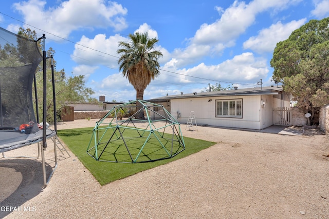 8142 Cook Dr, El Paso, TX 79907 - rear view of property with a trampoline
