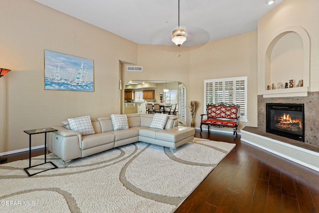 6310 Franklin Crest Dr, El Paso, TX 79912 - living room with arched walkways, hardwood / wood-style floors, and a glass covered fireplace