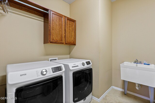 6310 Franklin Crest Dr, El Paso, TX 79912 - laundry room with cabinet space and washer and dryer