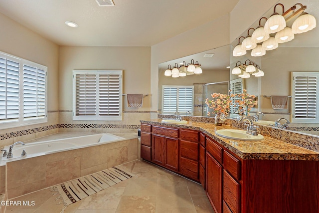 6310 Franklin Crest Dr, El Paso, TX 79912 - full bathroom with double vanity, a bath, a shower stall, and tile patterned flooring