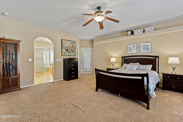 6310 Franklin Crest Dr, El Paso, TX 79912 - bedroom with light carpet, arched walkways, ensuite bath, and ceiling fan