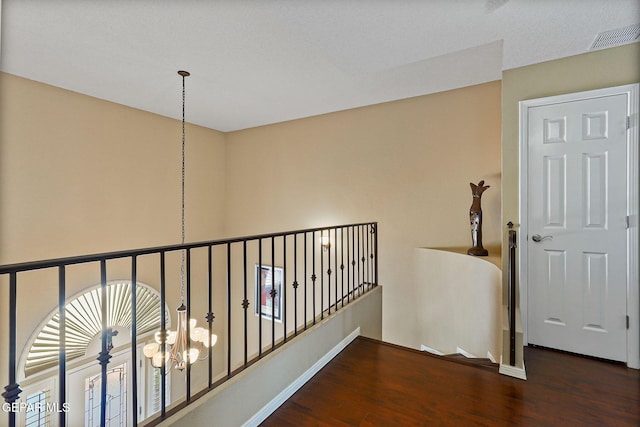 6310 Franklin Crest Dr, El Paso, TX 79912 - corridor featuring wood finished floors, a chandelier, and an upstairs landing