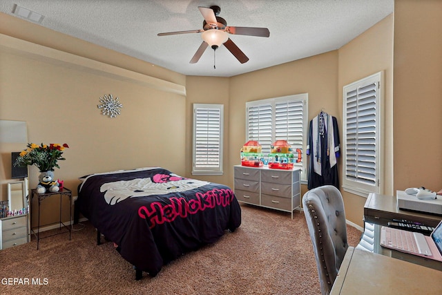 6310 Franklin Crest Dr, El Paso, TX 79912 - carpeted bedroom with a desk, a ceiling fan, and a textured ceiling