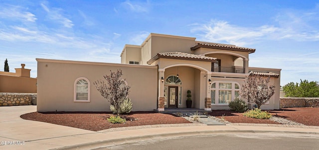 6310 Franklin Crest Dr, El Paso, TX 79912 - mediterranean / spanish-style house featuring a balcony, stucco siding, a tile roof, and driveway