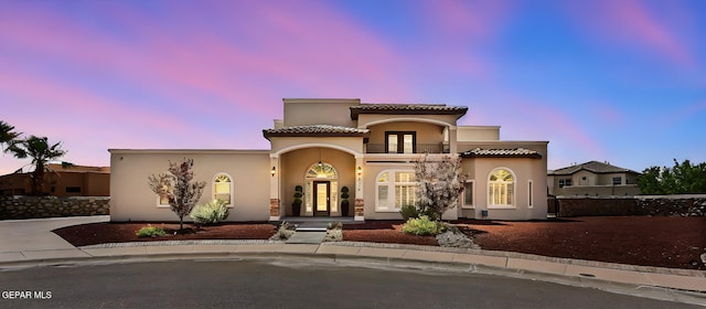 6310 Franklin Crest Dr, El Paso, TX 79912 - mediterranean / spanish house featuring a balcony, french doors, stucco siding, and a tile roof