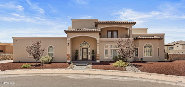 6310 Franklin Crest Dr, El Paso, TX 79912 - view of front of home with a balcony, stucco siding, and a tiled roof