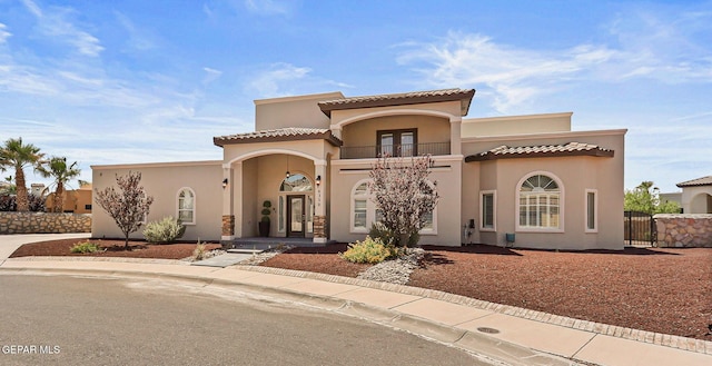 6310 Franklin Crest Dr, El Paso, TX 79912 - mediterranean / spanish house featuring a balcony, french doors, stucco siding, and a gate
