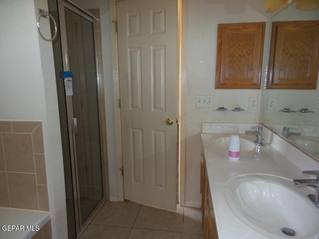 3204 Olive Point Dr, El Paso, TX 79938 - full bathroom with tile patterned floors, double vanity, and a shower stall