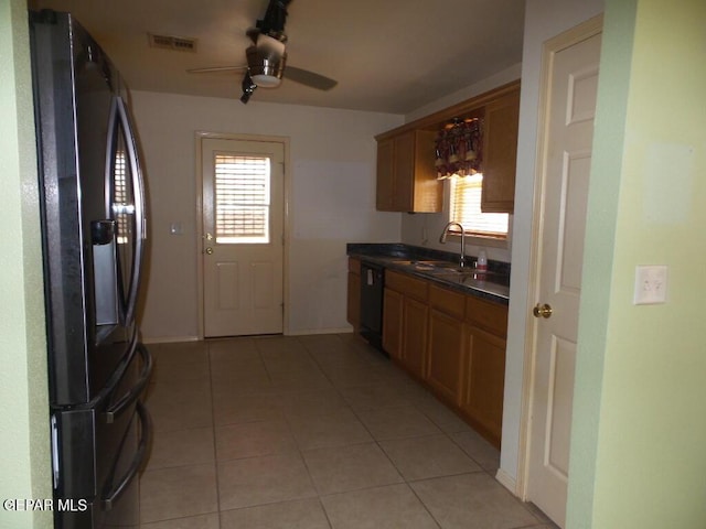 3204 Olive Point Dr, El Paso, TX 79938 - kitchen featuring fridge with ice dispenser, dark countertops, ceiling fan, light tile patterned floors, and brown cabinetry