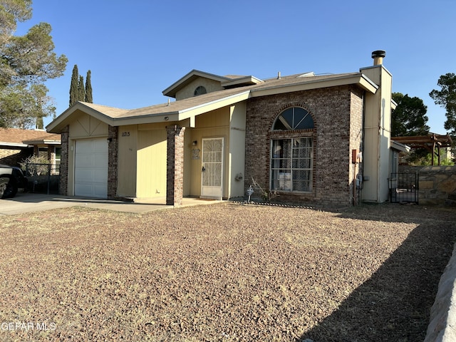 11713 Francis Scobee Dr, El Paso, TX 79936 - view of front of property with a garage, driveway, a gate, and brick siding