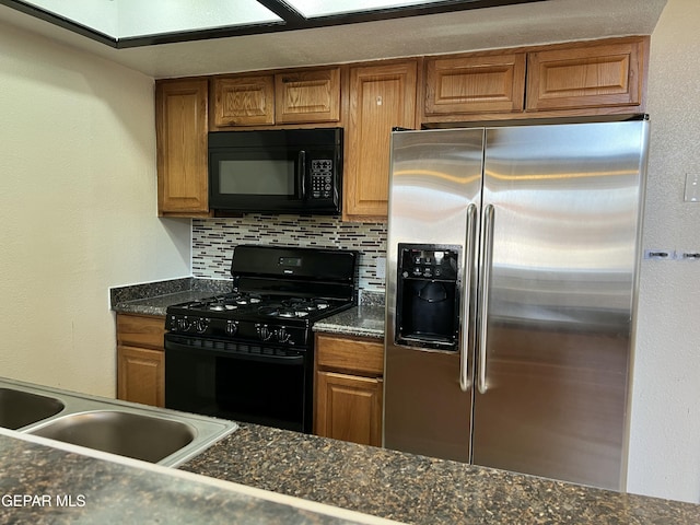 11713 Francis Scobee Dr, El Paso, TX 79936 - kitchen with black appliances, brown cabinetry, and tasteful backsplash