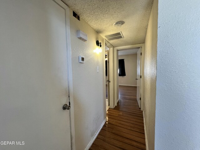 11713 Francis Scobee Dr, El Paso, TX 79936 - corridor featuring a textured wall, a textured ceiling, and wood finished floors